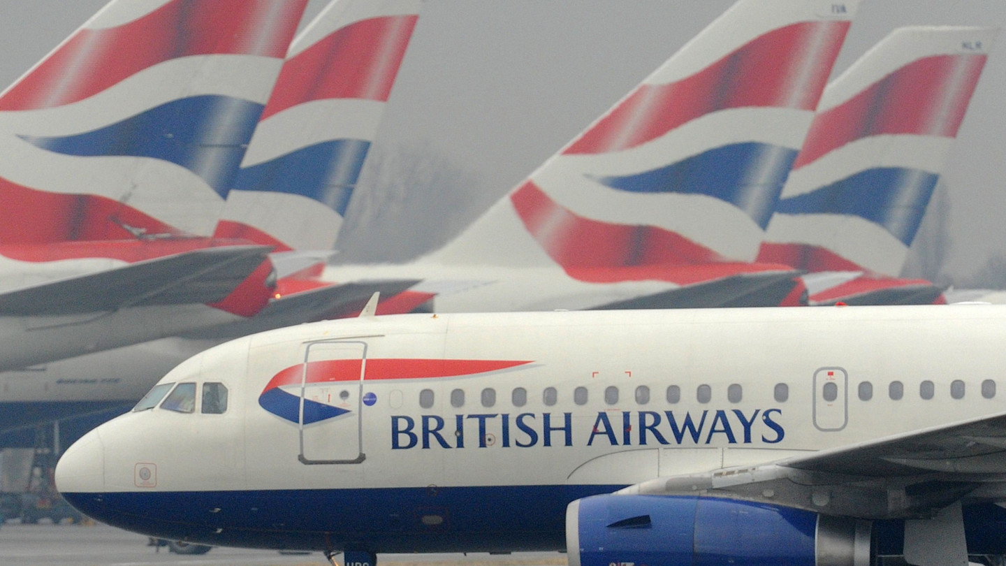 A British Airways passenger jet taxis past several other BA planes at Heathrow airport