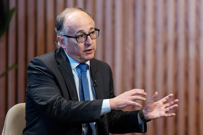 Luis Gallego gestures while speaking during an interview.