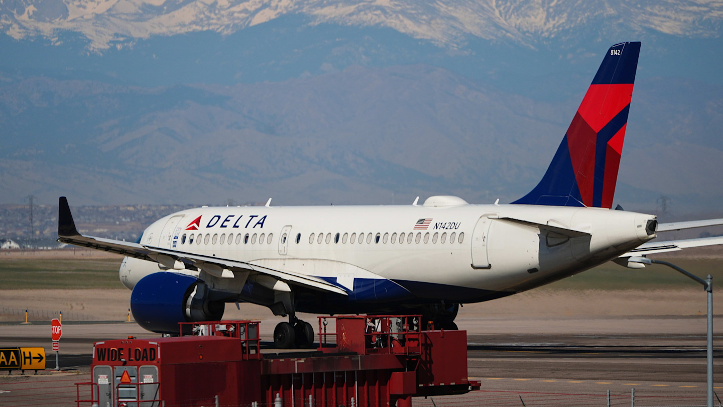 A Delta Air Lines jetliner taxis on a runway at Denver International airport 