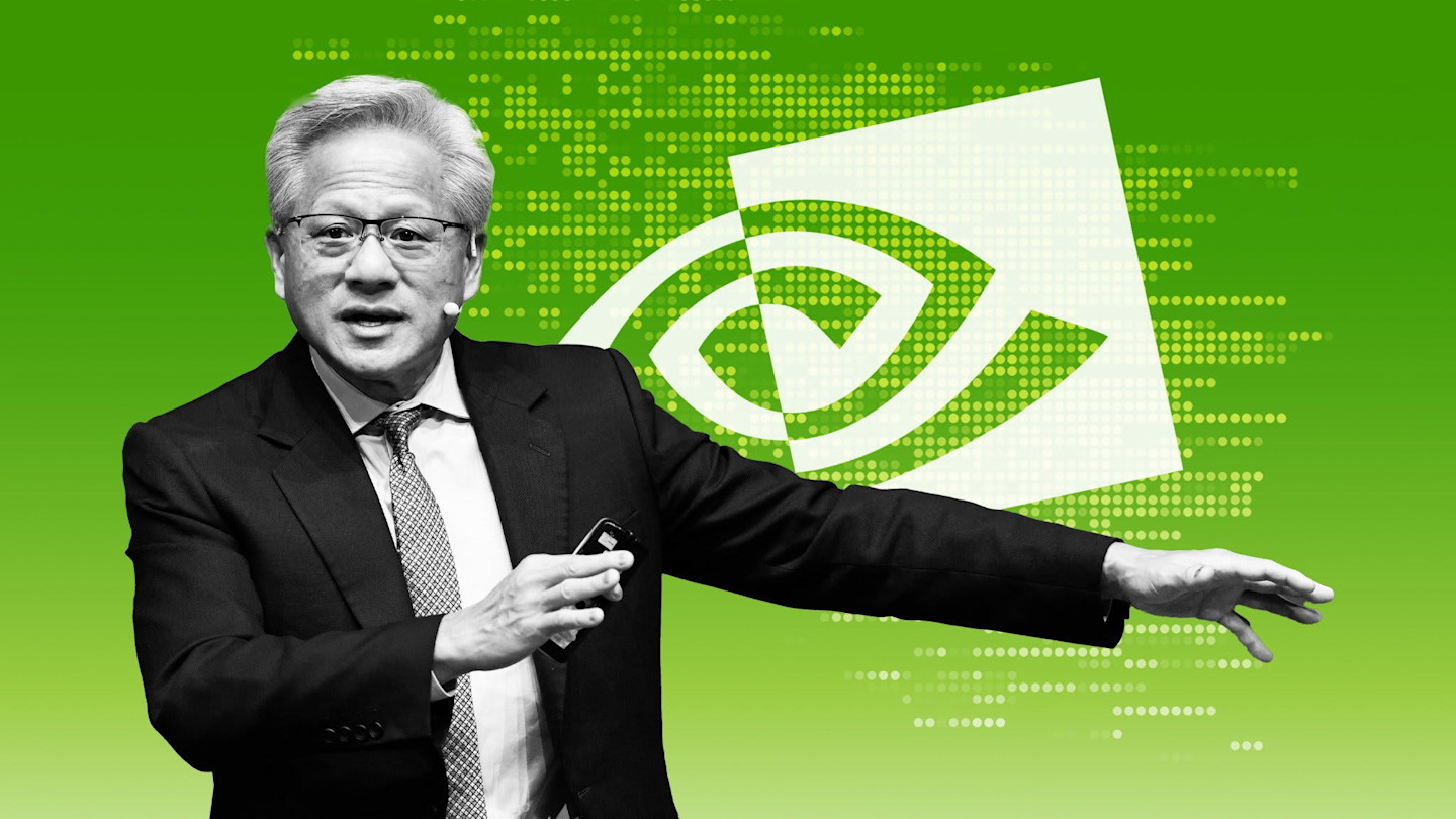 Jensen Huang gestures while standing in front of a large Nvidia logo on a green background with digital dot patterns.