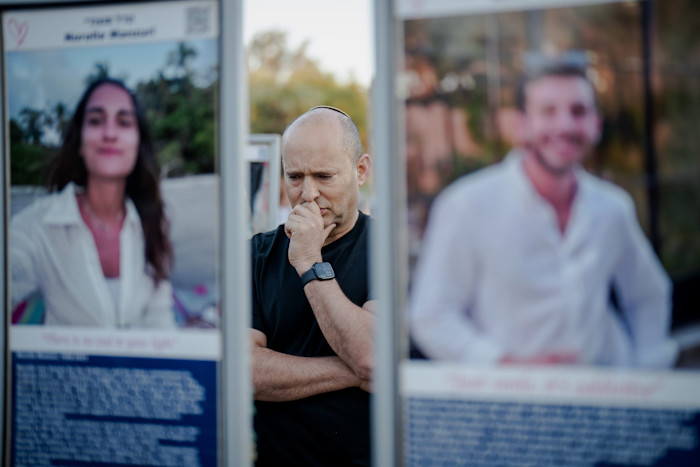 Naftali Bennett looks at a memorial for victims of the October 7 2023 attacks in Re’im, Israel