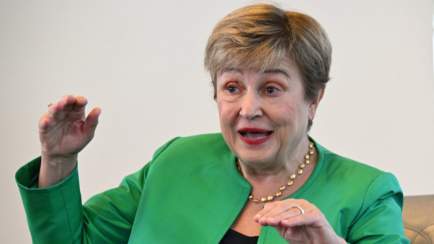 IMF managing director Kristalina Georgieva gestures with both hands while speaking during an interview. She is wearing a green jacket and gold-beaded necklace.