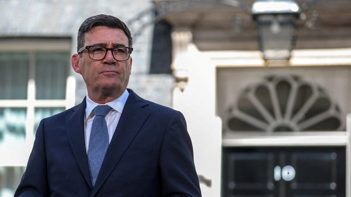 Andy Burnham stands outside 10 Downing Street, wearing a suit and tie