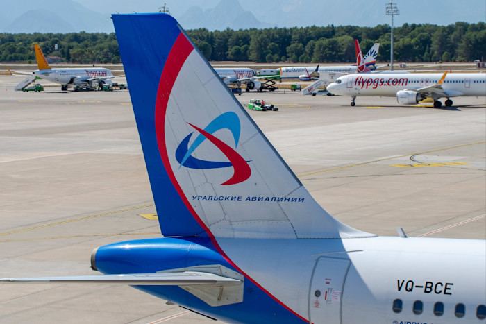 Ural Airlines Airbus A321-200 tail with logo and registration VQ-BCE visible, parked on the apron at Antalya Airport.