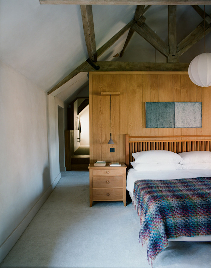 Bespoke wardrobes designed by Richard Parr and made by Carlton Smith, a Duxiana bed, Providence bedside tables and artwork by Stephen Rothschild in the master bedroom