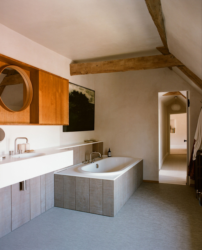 A Bette bath, Carlton Smith cabinetry and painting by Sax Impey in a guest bathroom