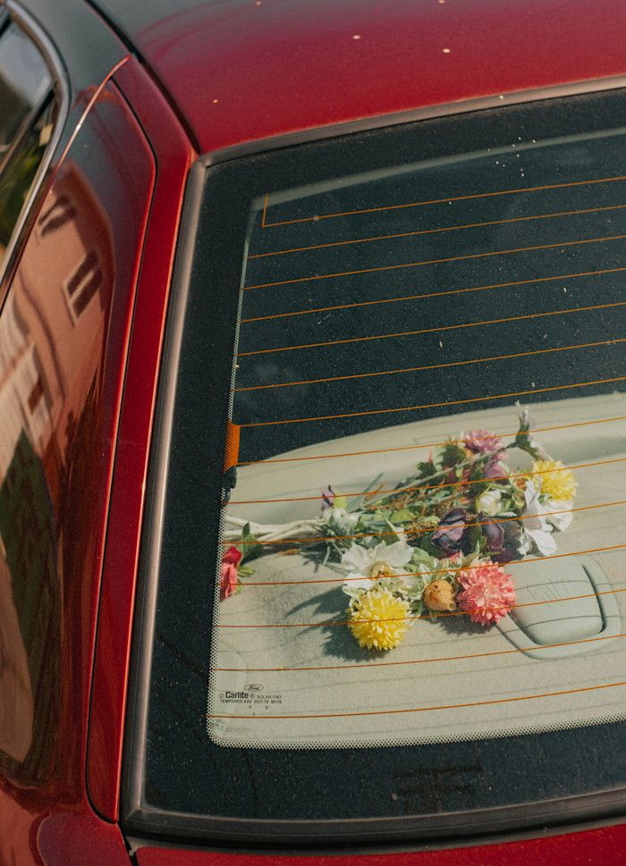 Flowers on the parcel shelf of a Ford