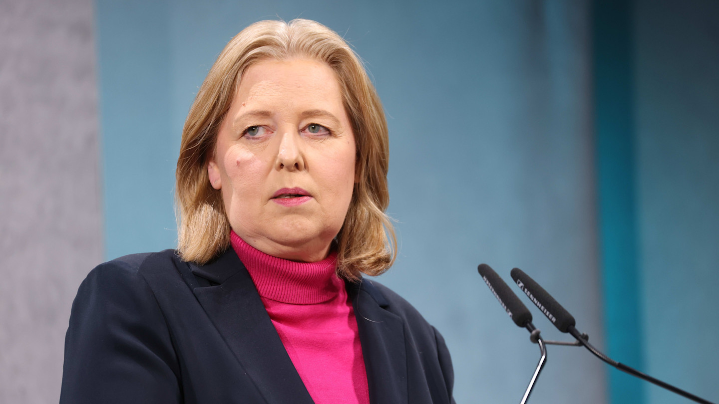 Bärbel Bas stands at a podium with microphones during the Süddeutsche Zeitung Economic Summit.