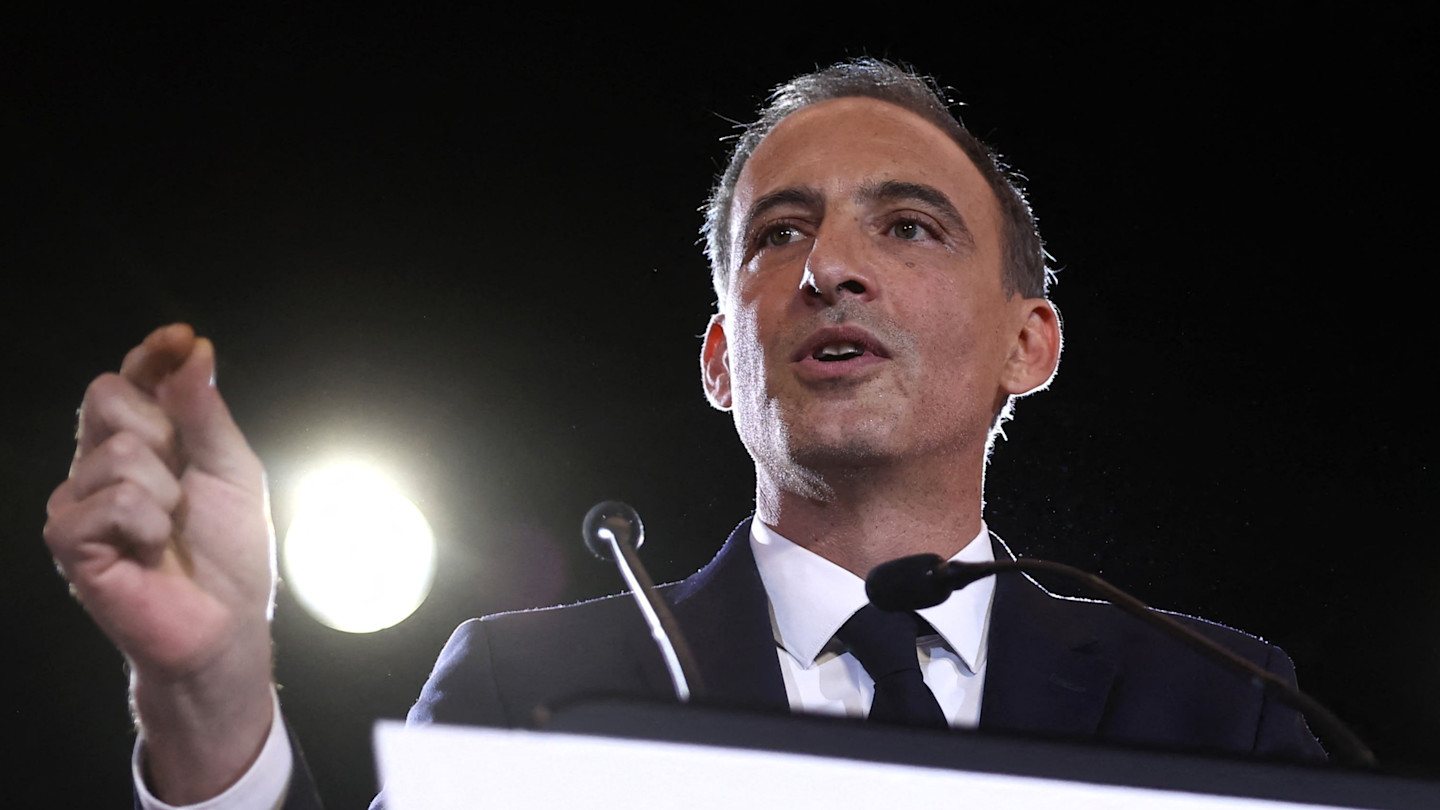 Raphaël Glucksmann speaks at a podium, gesturing with his hand, after winning the left primary for France’s 2027 presidential election.