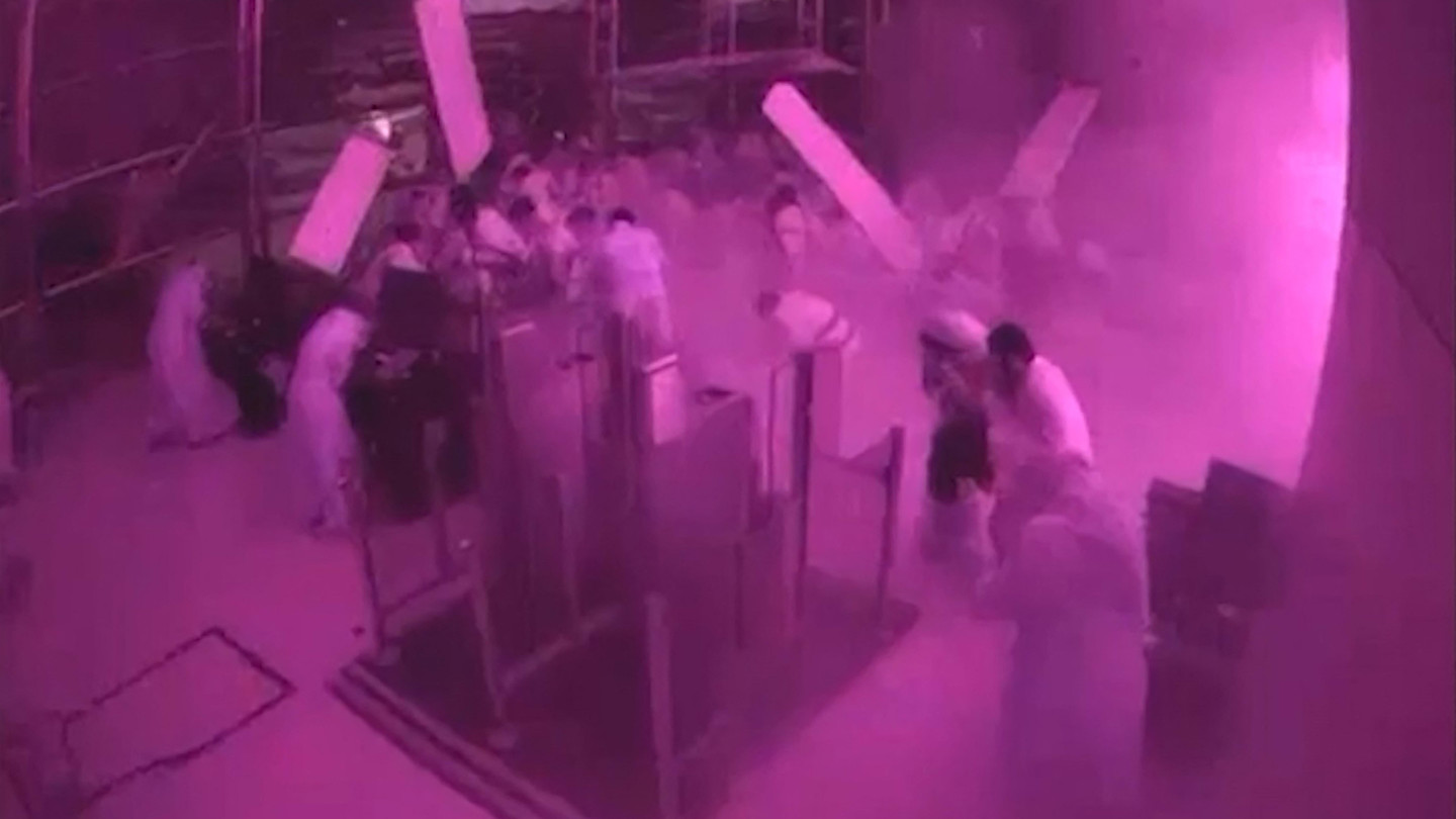 Surveillance footage shows people ducking and taking cover amid smoke and debris inside Riyadh International Airport during a strike.