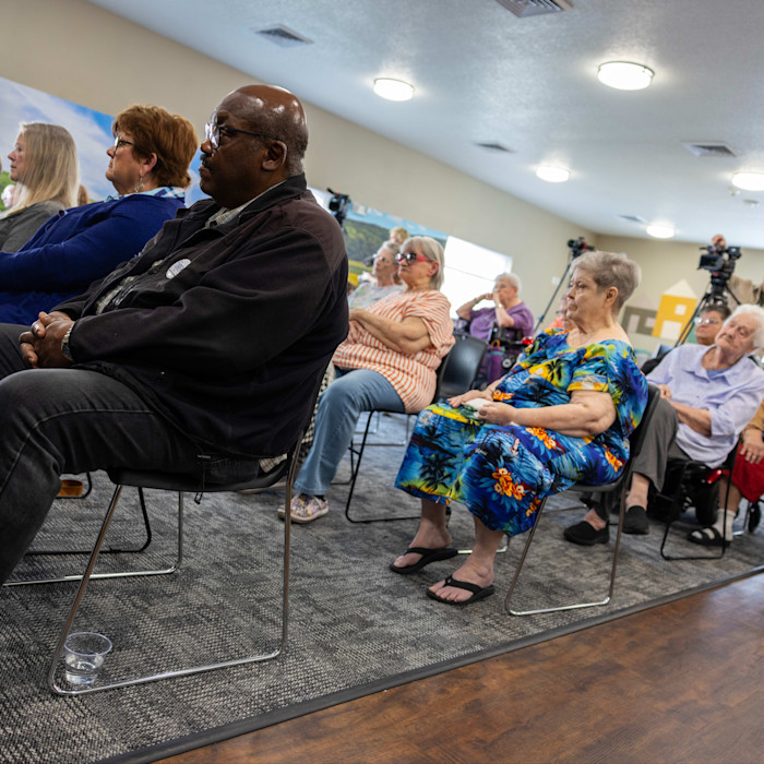 Voters listen to Josh Turek speak during an event in Des Moines