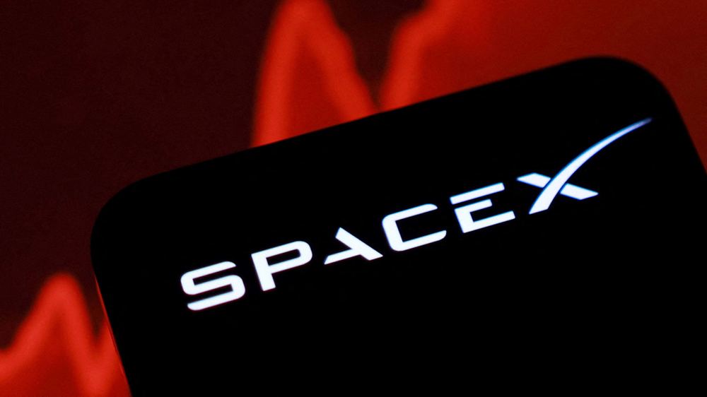 An illustration shows the SpaceX logo on a screen with a rising stock graph in the background.