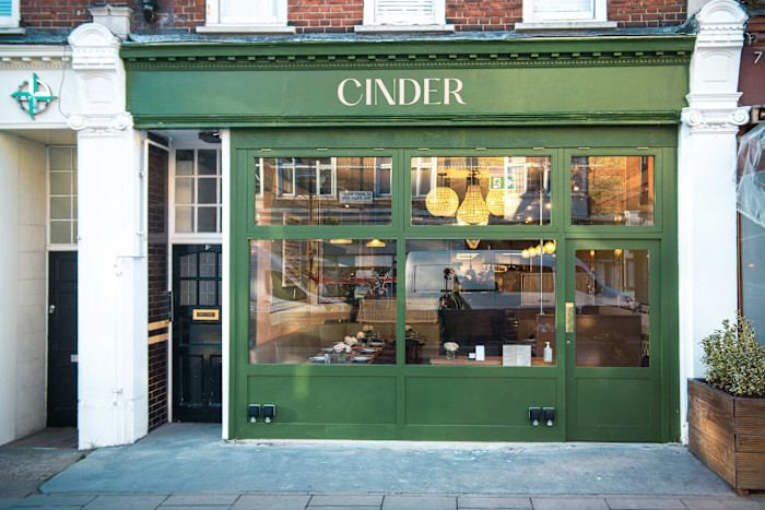 A green-painted shopfront with large windows and a sign reading Cidre.