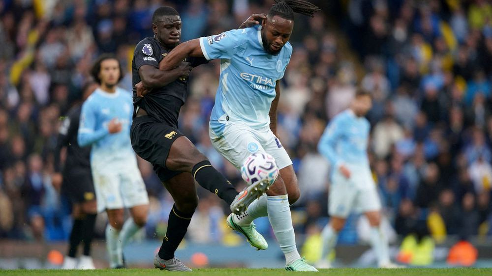 Antoine Semenyo of Manchester City battles for the ball with Ipswich Town's Azor Matusiwa during a Premier League match.