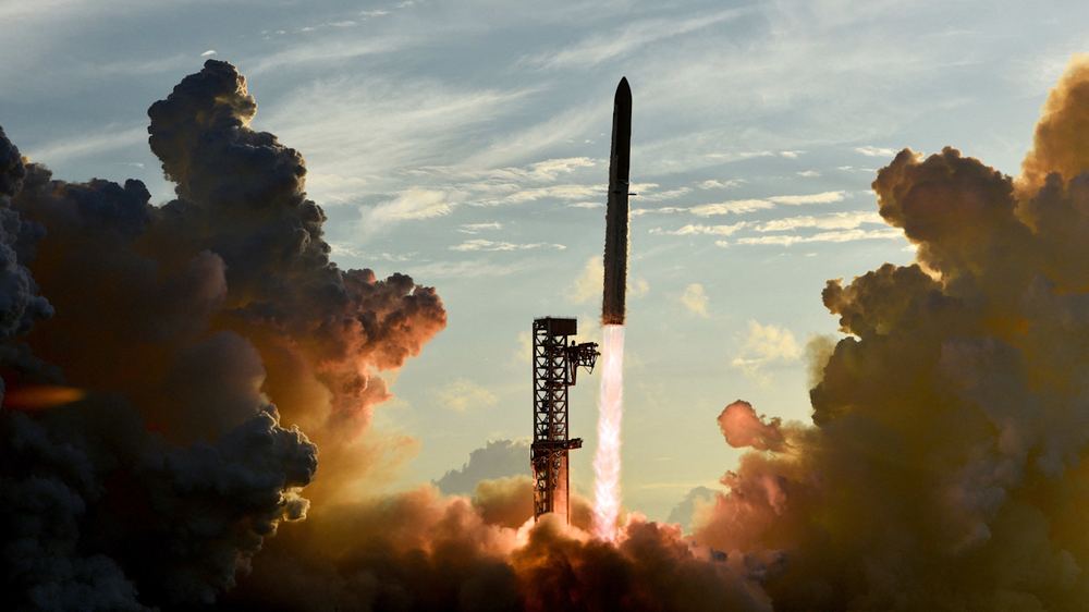 SpaceX Starship and Super Heavy v3 Booster launch, with bright exhaust flames and thick clouds of smoke surrounding the pad.