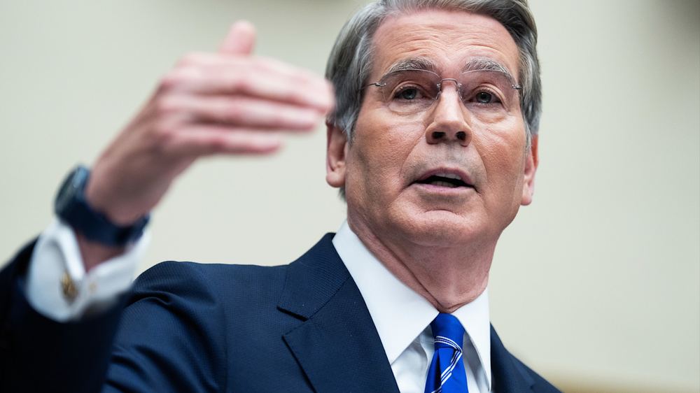 Scott Bessent speaks and gestures with his hand while testifying during a House Financial Services Committee hearing.